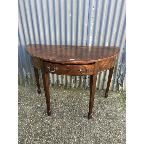 41 - A mahogany demi lune hall table 116cm wide