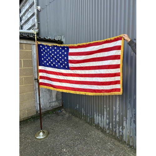 42 - An American flag on pole with stand