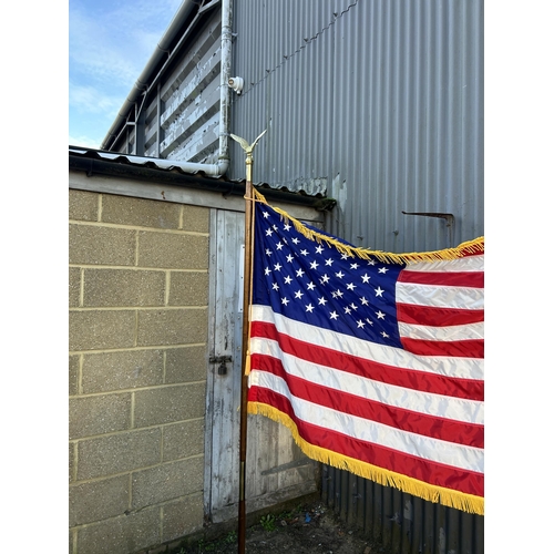 42 - An American flag on pole with stand