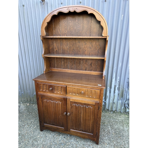 55 - An oak linenfold cottage dresser 96 cm wide