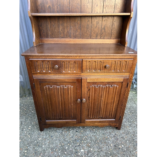 55 - An oak linenfold cottage dresser 96 cm wide