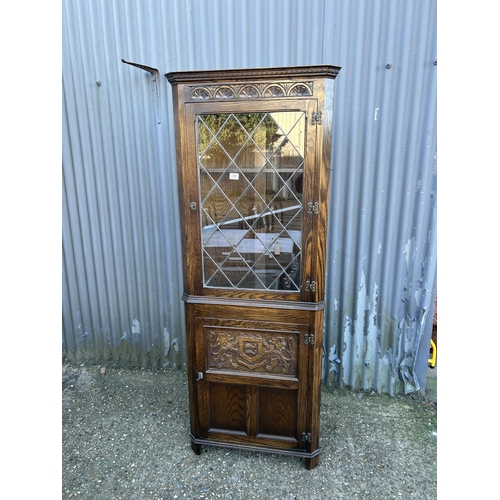 58 - A carved oak lead glass corner cabinet