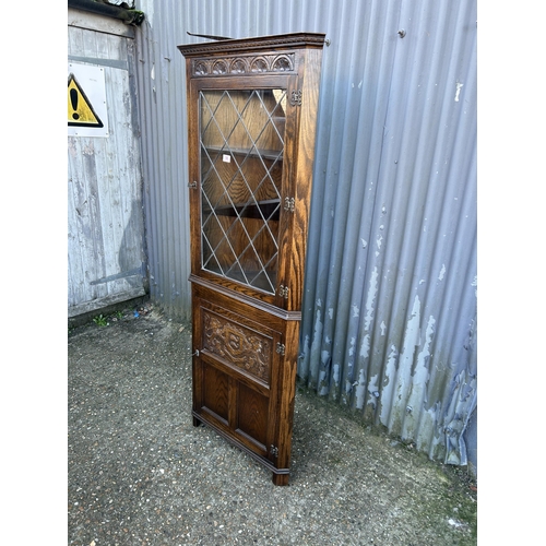 58 - A carved oak lead glass corner cabinet