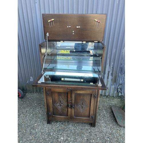 59 - An old charm carved oak drinks cabinet