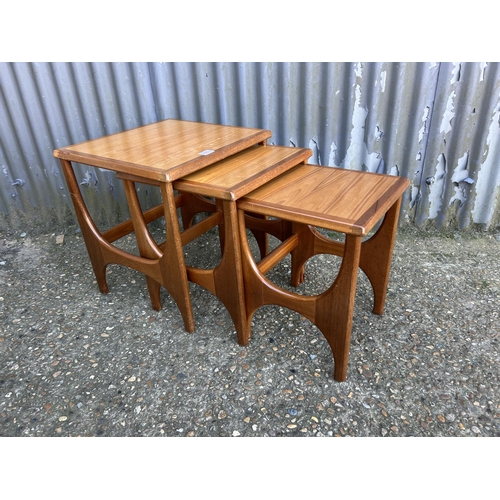 66 - A teak nest of three tables