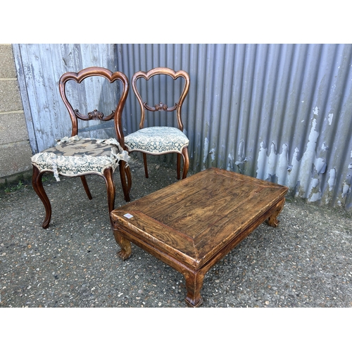 69 - A rustic style coffee table and a pair of Victorian balloon back chairs