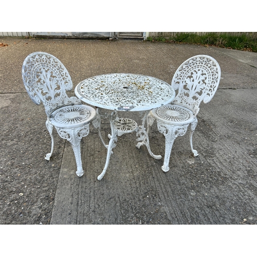 74 - A vintage white painted aluminium garden table and two chairs