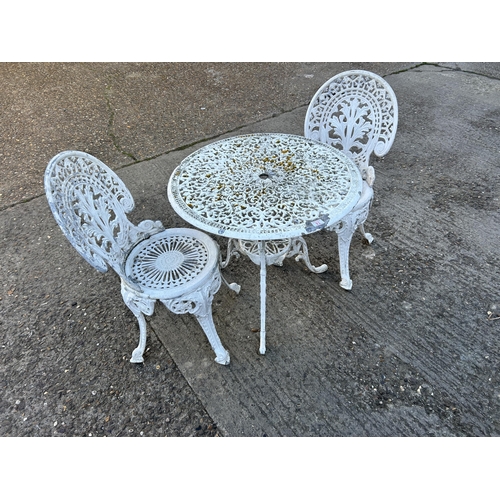 74 - A vintage white painted aluminium garden table and two chairs