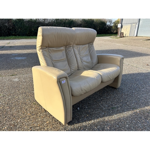 75 - A cream leather two seater reclining sofa possibly EKORNES