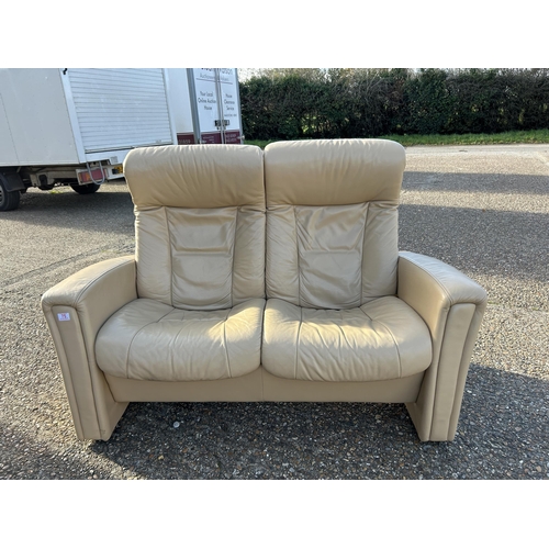 75 - A cream leather two seater reclining sofa possibly EKORNES