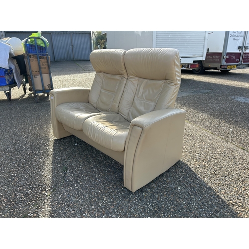 75 - A cream leather two seater reclining sofa possibly EKORNES