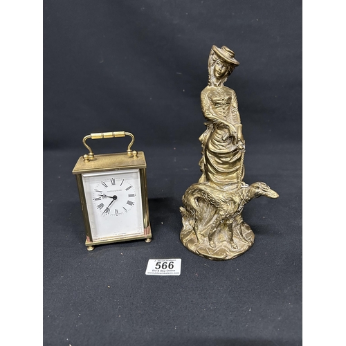 566 - Mappin and Webb battery carriage clock and brass lady and dog figure, height 23cms