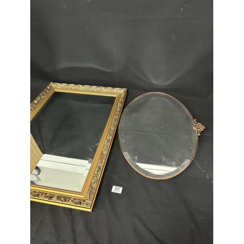 597 - Bevelled gilt framed mirror, 53 x 76cms and metal framed oval mirror