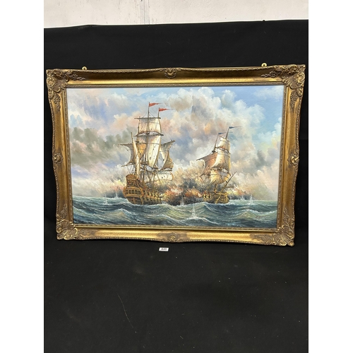 645 - Signed oil on board, Two Galleons at war in gilt frame, 103 x 73cms