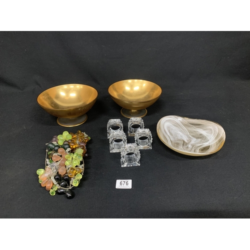 676 - Antique glass grapes, cut glass napkin rings, pair of gold colour glass bowls and coffee cream swirl... 