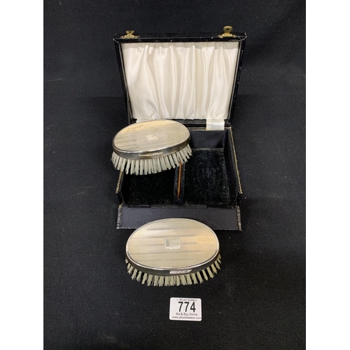 774 - A cased pair of Hallmarked silver brushes