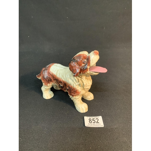 852 - Cast iron dog with moving tail and tongue,length 19cm