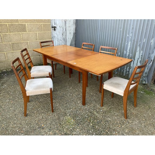 144 - An extending teak dining table together with a set of six dining chairs max size 200x90x77