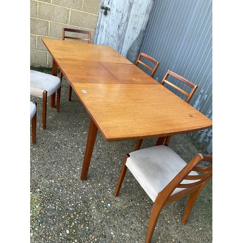 144 - An extending teak dining table together with a set of six dining chairs max size 200x90x77