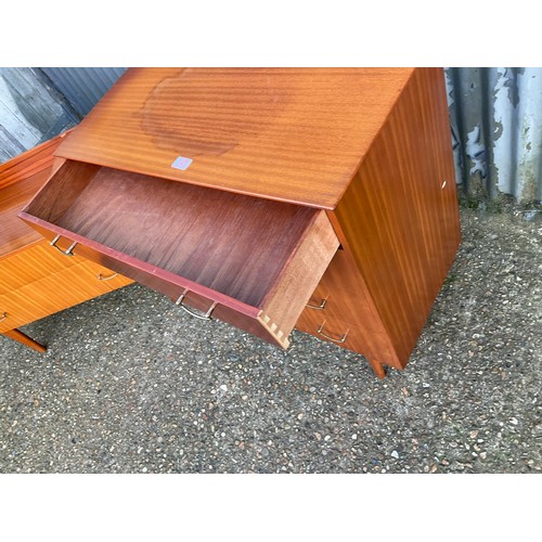 145 - A mid century teak bedroom pair consisting of chest of drawers and matching desk