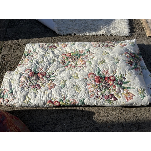 169 - A floral king size bed quilt, fluffy rug and beige rug