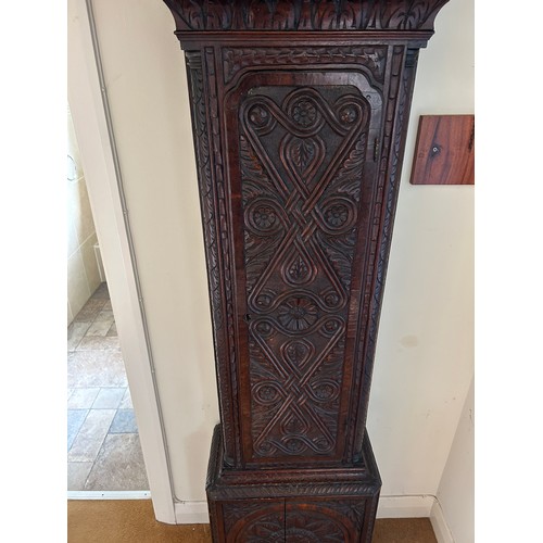 170 - An oak carved long case clock with brass dial by HENRY FISHER OF PRESTON