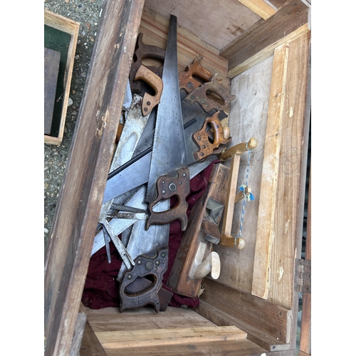 100 - A large vintage pine tool chest with saws and block planes