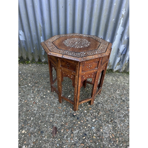 105 - Eastern style mother of pearl inlaid occasional table in folding base