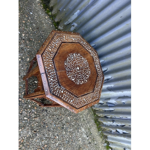 105 - Eastern style mother of pearl inlaid occasional table in folding base