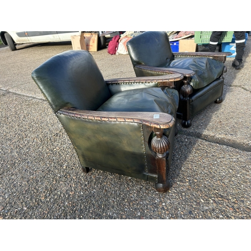 115 - A pair of oak framed club style chairs with green leather upholstery