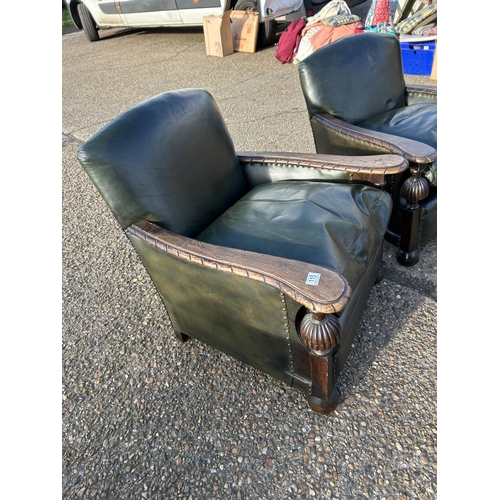 115 - A pair of oak framed club style chairs with green leather upholstery