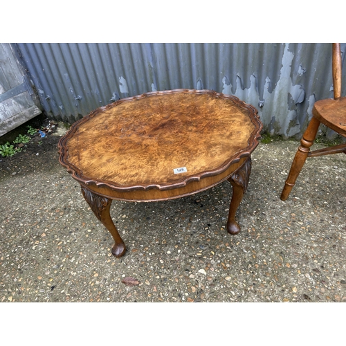 128 - A smokers bow back desk chair together with a walnut pie crust coffee table