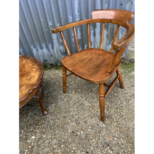 128 - A smokers bow back desk chair together with a walnut pie crust coffee table