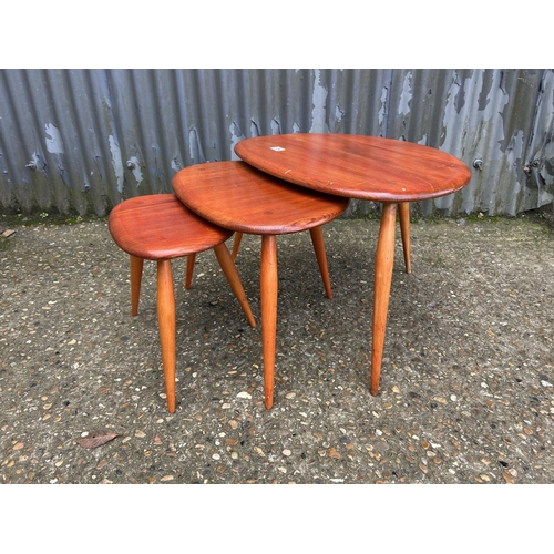 134 - An ercol pebble nest of three occasional tables