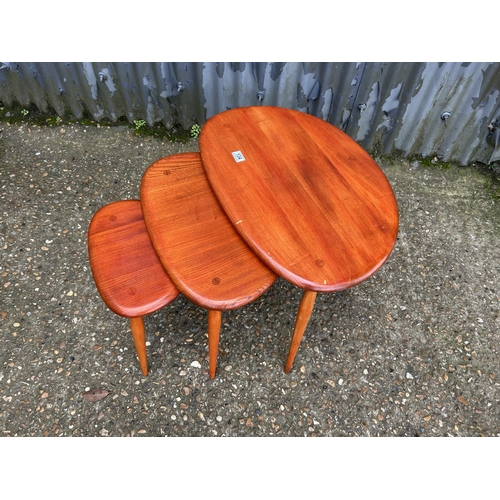 134 - An ercol pebble nest of three occasional tables