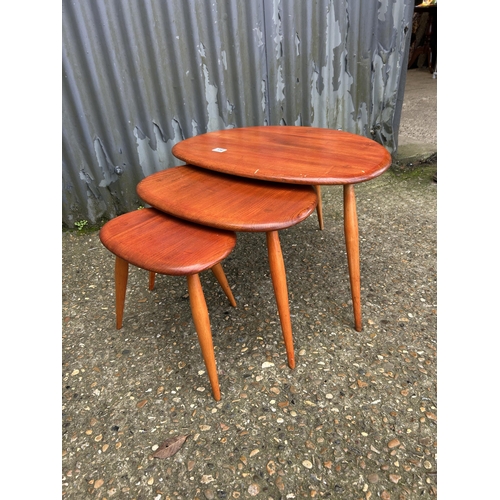 134 - An ercol pebble nest of three occasional tables