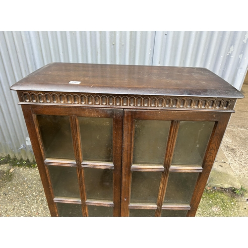 147 - A glazed oak two door cabinet 80x35x132