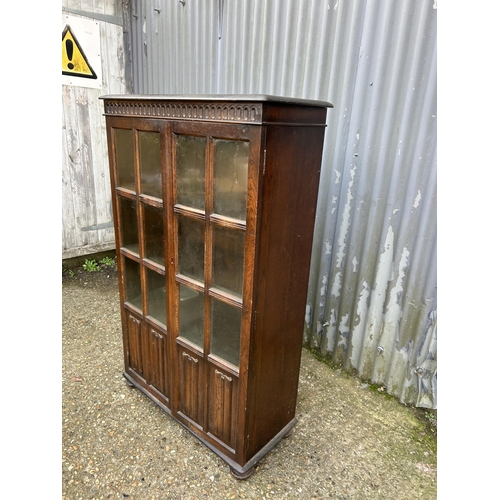 147 - A glazed oak two door cabinet 80x35x132