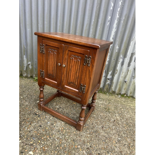 156 - Old charm oak two door cuobaord together with matching circular coffee table