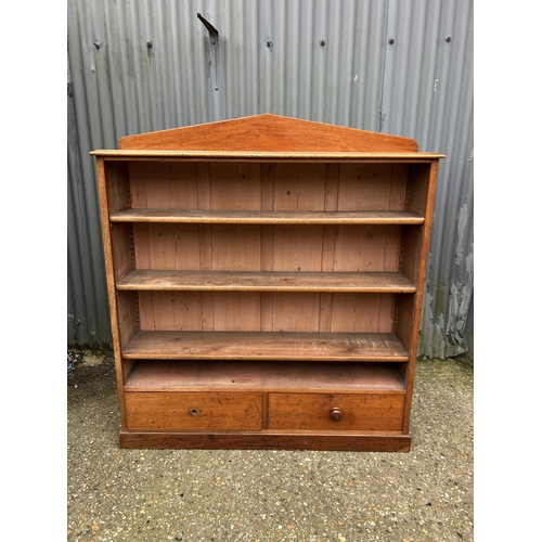 190 - A Victorian mahogany open bookcase with three shelves over two drawers  136x 36x150