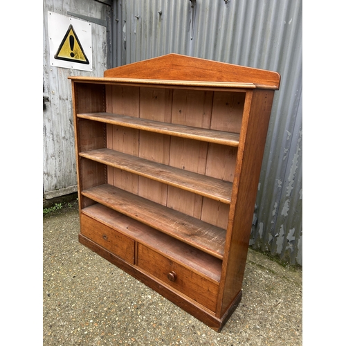 190 - A Victorian mahogany open bookcase with three shelves over two drawers  136x 36x150