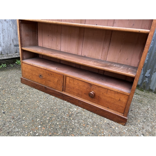 190 - A Victorian mahogany open bookcase with three shelves over two drawers  136x 36x150