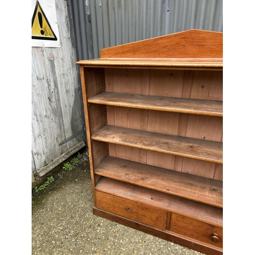 190 - A Victorian mahogany open bookcase with three shelves over two drawers  136x 36x150