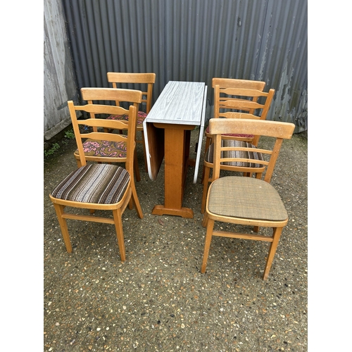 194 - A retro formica drop leaf table and six chairs (4+2)