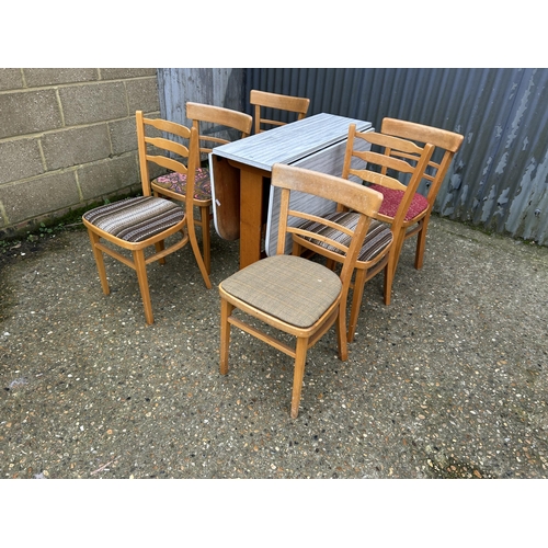 194 - A retro formica drop leaf table and six chairs (4+2)