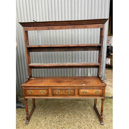 231 - A oak three drawer dresser with plate rack top 152cm wide