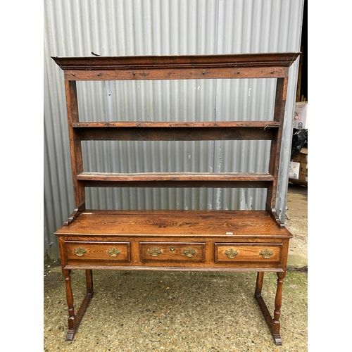 231 - A oak three drawer dresser with plate rack top 152cm wide