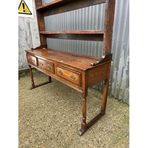 231 - A oak three drawer dresser with plate rack top 152cm wide