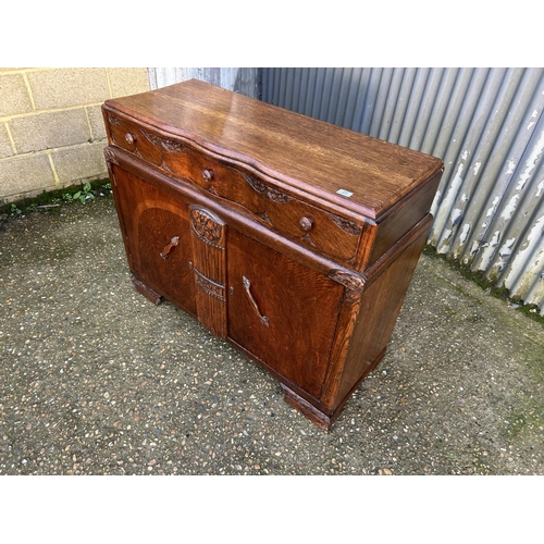 27 - Three drawer 20th century oak sideboard