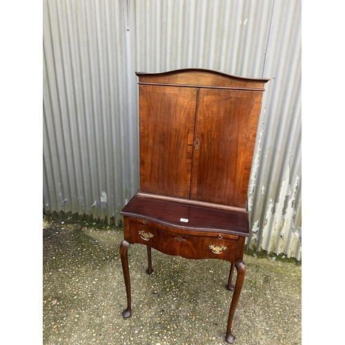 35 - A mahogany two door cuobaord on a single drawer stand